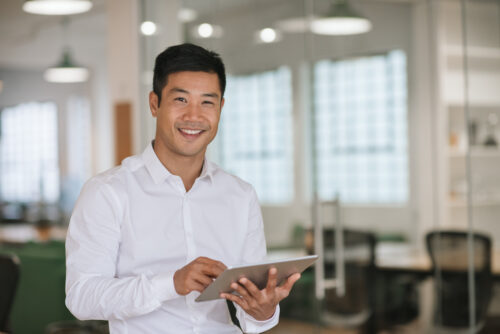 Person using tablet in office setting.